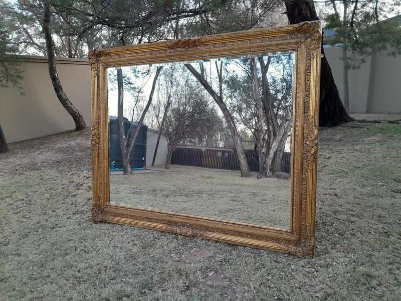 A Massive 20TH Century French Style Ornately Carved And Gilded Bevelled Mirror Of Large Proportions