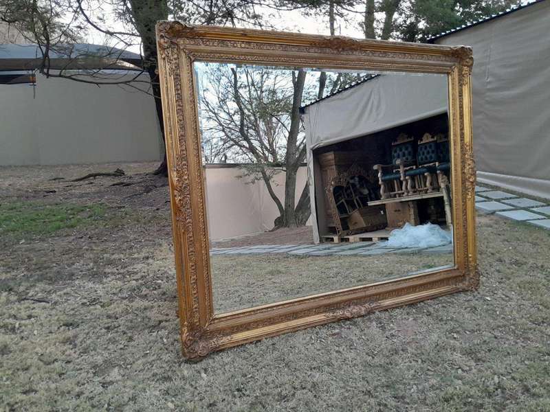 A Massive 20TH Century French Style Ornately Carved And Gilded Bevelled Mirror Of Large Proportions