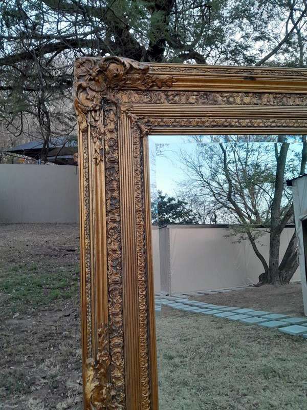 A Massive 20TH Century French Style Ornately Carved And Gilded Bevelled Mirror Of Large Proportions
