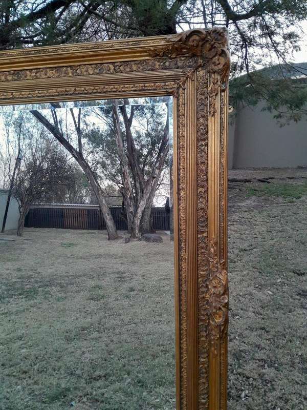 A Massive 20TH Century French Style Ornately Carved And Gilded Bevelled Mirror Of Large Proportions