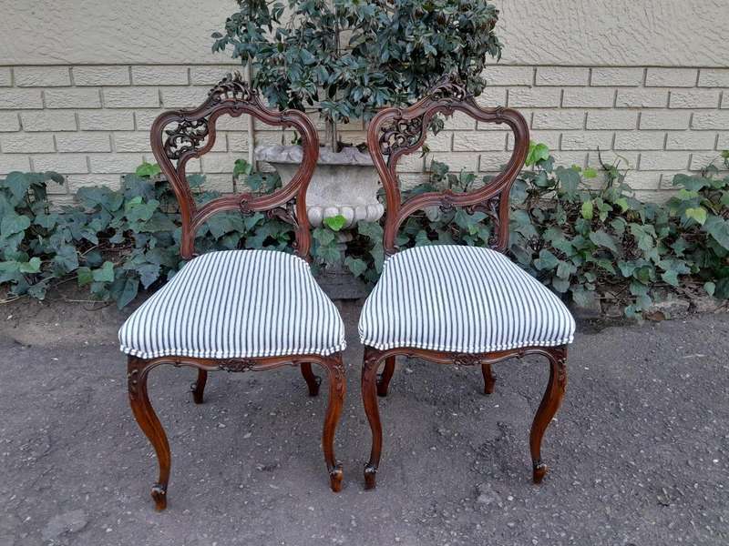 An Early 20th Century Pair Of French Carved Mahogany Chairs