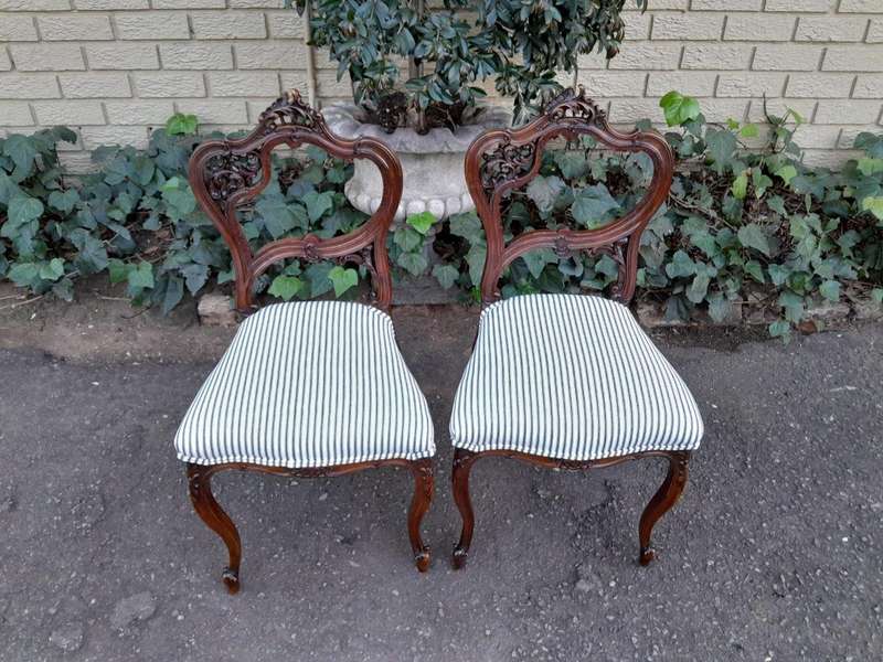 An Early 20th Century Pair Of French Carved Mahogany Chairs