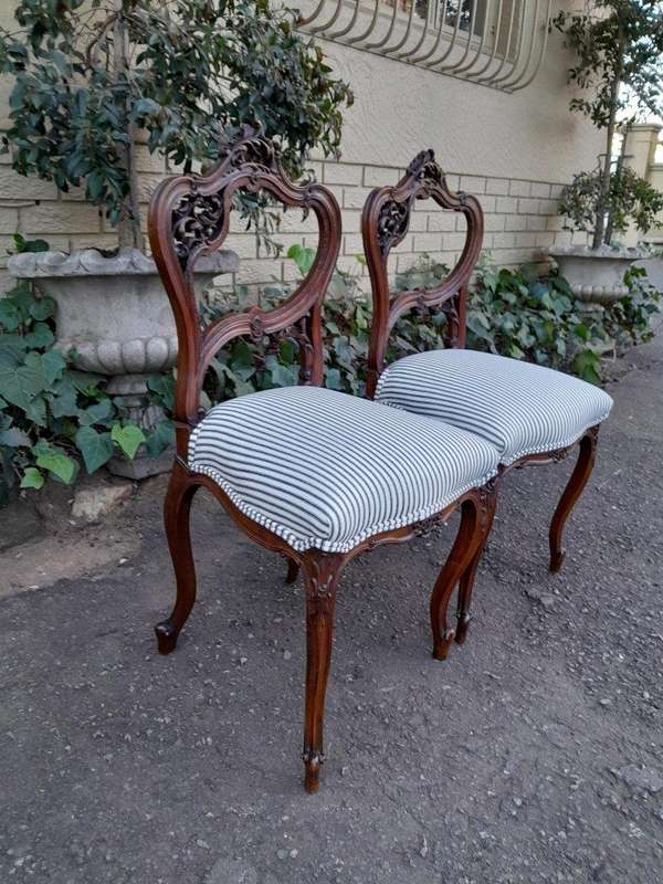 An Early 20th Century Pair Of French Carved Mahogany Chairs