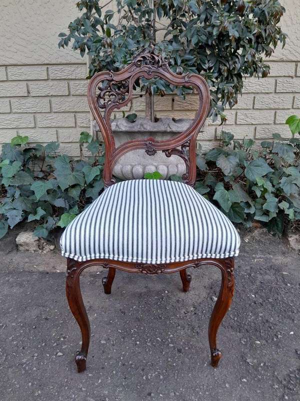 An Early 20th Century Pair Of French Carved Mahogany Chairs