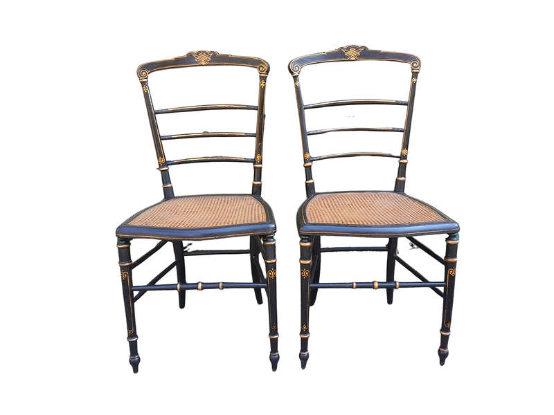 A Late 19th Century Circa 1880s Pair Of Victorian Ebonised And Gilt Painted Wooden Rattan Chairs