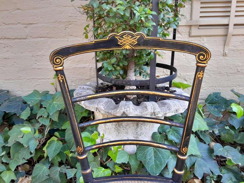 A Late 19th Century Circa 1880s Pair Of Victorian Ebonised And Gilt Painted Wooden Rattan Chairs