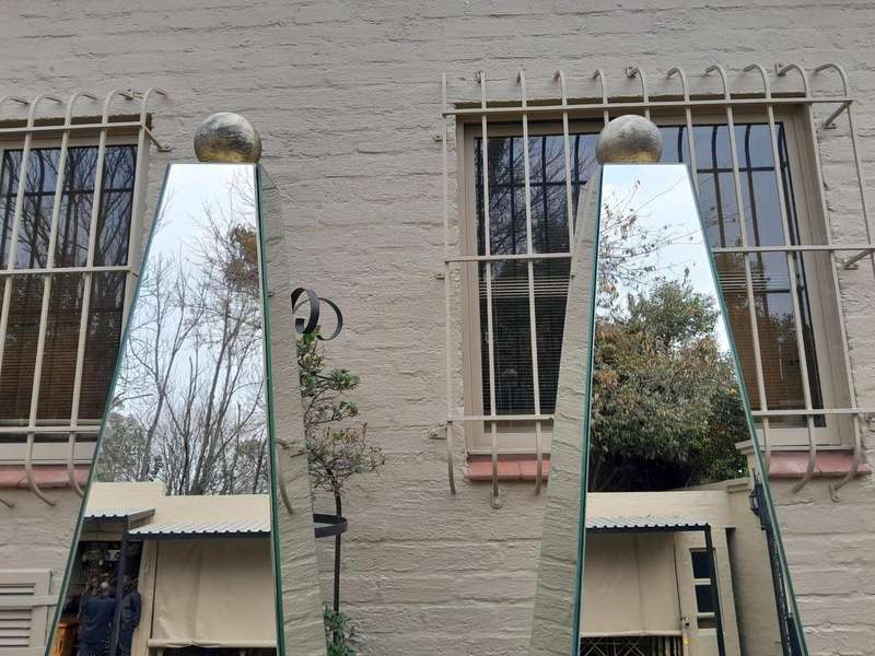A Pair of Designer Mirror and Antique Gold Coloured Iron Obelisks with Ball Detail, Custom-made f...