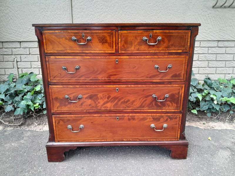 An Antique George III Style Flame Mahogany Chest Of Drawers On Bracket Feet
