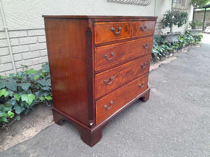 An Antique George III Style Flame Mahogany Chest Of Drawers On Bracket Feet