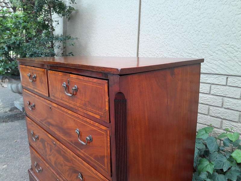 An Antique George III Style Flame Mahogany Chest Of Drawers On Bracket Feet