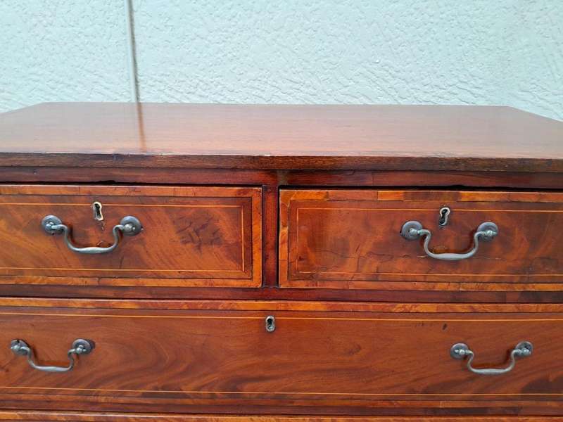 An Antique George III Style Flame Mahogany Chest Of Drawers On Bracket Feet