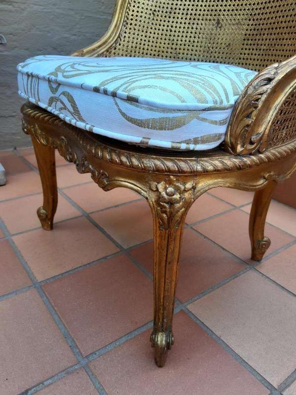 A 20th Century French Style Giltwood Rattan Chair Upholstered In Hand Printed Gold Design Fabric 