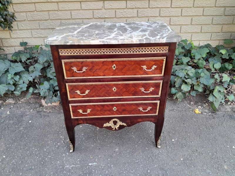 A 20th Century Parquetry Chest Of Drawers With Gilt Mounts And Marble Top