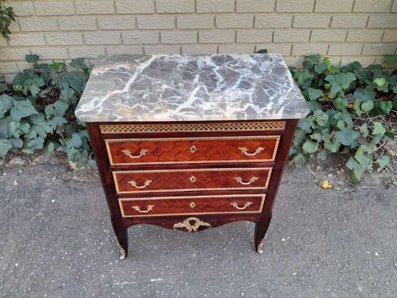 A 20th Century Parquetry Chest Of Drawers With Gilt Mounts And Marble Top