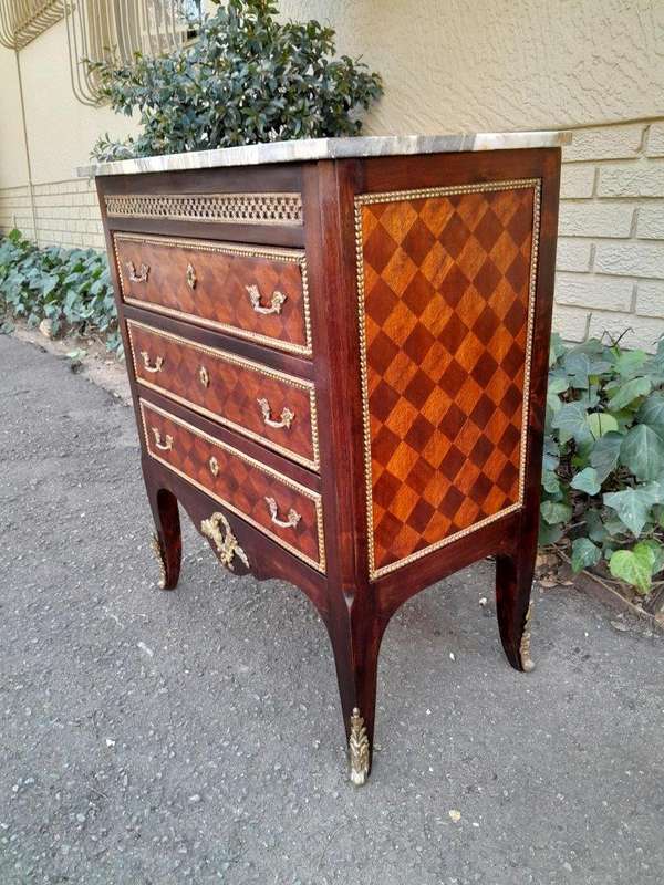 A 20th Century Parquetry Chest Of Drawers With Gilt Mounts And Marble Top