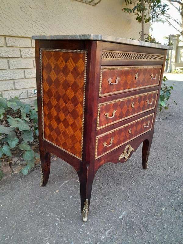 A 20th Century Parquetry Chest Of Drawers With Gilt Mounts And Marble Top