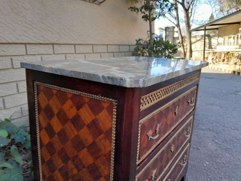 A 20th Century Parquetry Chest Of Drawers With Gilt Mounts And Marble Top