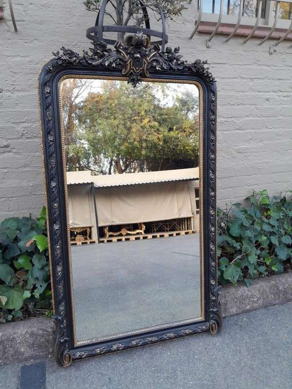 A 20th Century French Style Ebonized Hand-Gilt Ornate Mirror