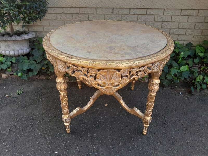 A French Style Ornately Carved and Gilded Wooden Table with Marble Top