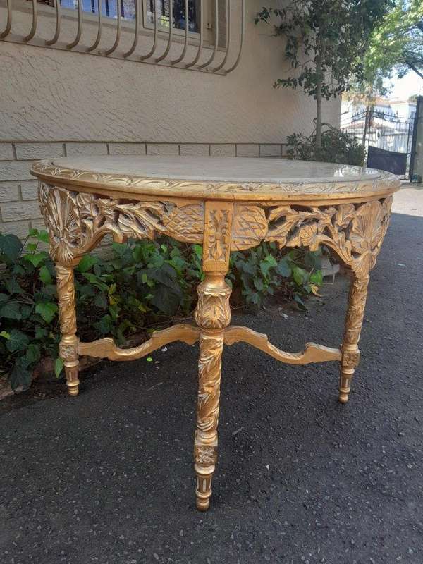 A French Style Ornately Carved and Gilded Wooden Table with Marble Top