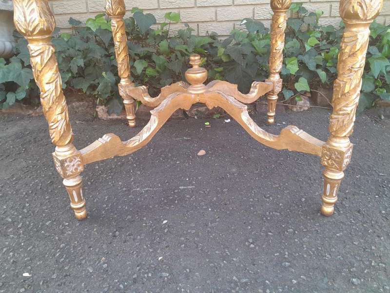 A French Style Ornately Carved and Gilded Wooden Table with Marble Top