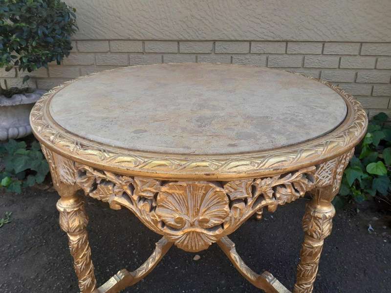 A French Style Ornately Carved and Gilded Wooden Table with Marble Top