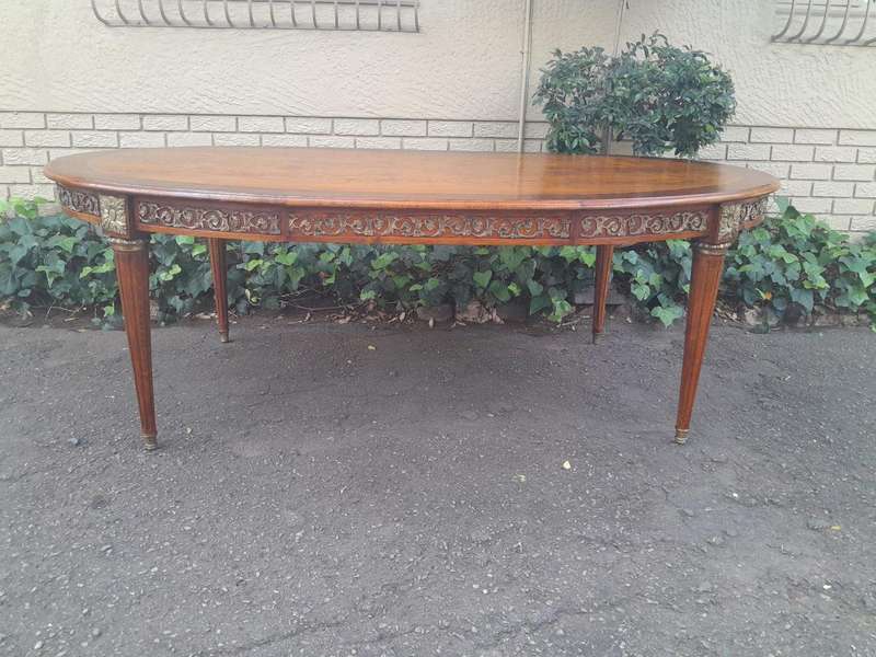 A 20th Century French Style Dining Table with Gold Detail