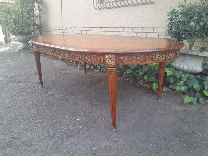 A 20th Century French Style Dining Table with Gold Detail