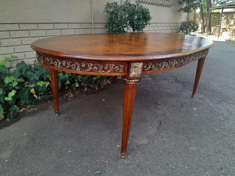 A 20th Century French Style Dining Table with Gold Detail