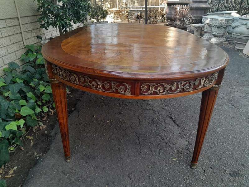 A 20th Century French Style Dining Table with Gold Detail