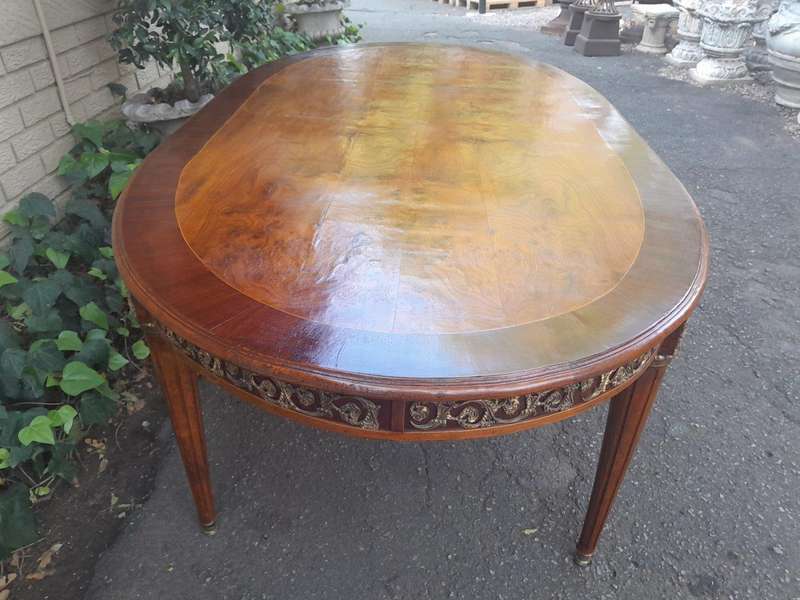 A 20th Century French Style Dining Table with Gold Detail