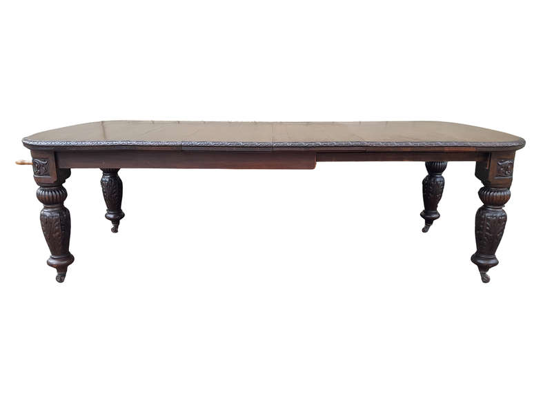 An Antique Victorian English Carved Oak Extending Dining Table on Castors and with Crank Handle