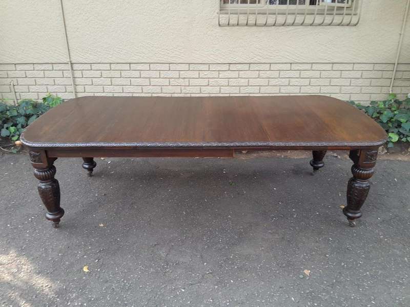 An Antique Victorian English Carved Oak Extending Dining Table on Castors and with Crank Handle