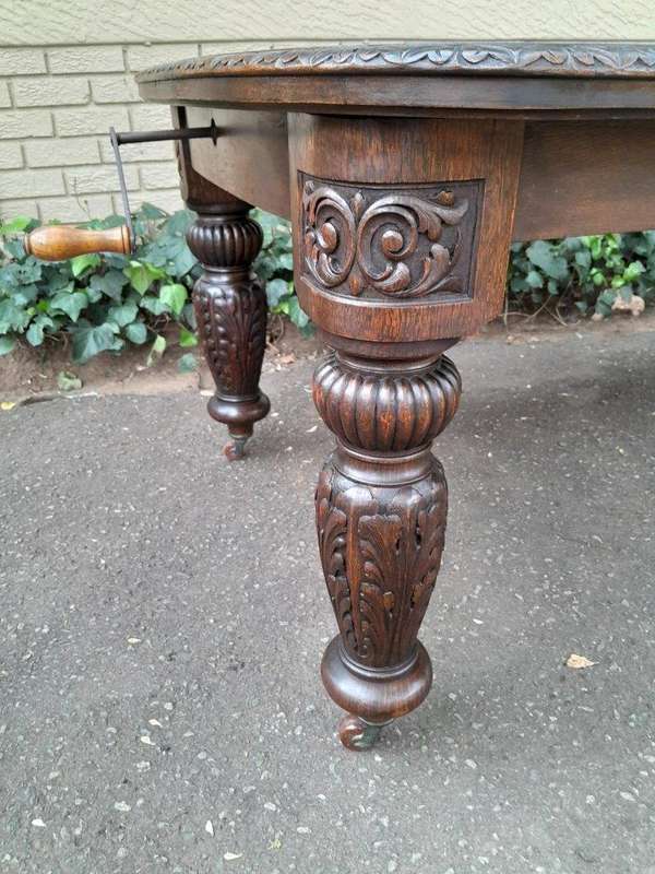 An Antique Victorian English Carved Oak Extending Dining Table on Castors and with Crank Handle