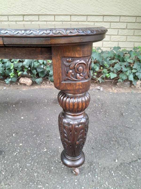 An Antique Victorian English Carved Oak Extending Dining Table on Castors and with Crank Handle