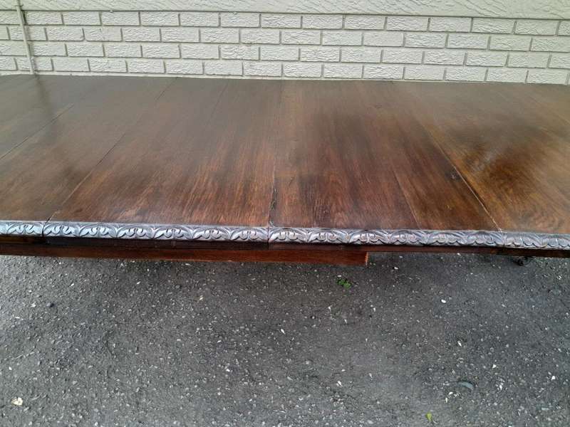 An Antique Victorian English Carved Oak Extending Dining Table on Castors and with Crank Handle
