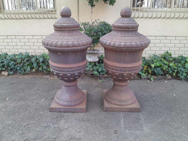 A Rare and Massive Extremely Heavy Pair of Cast Iron Urns with Tops