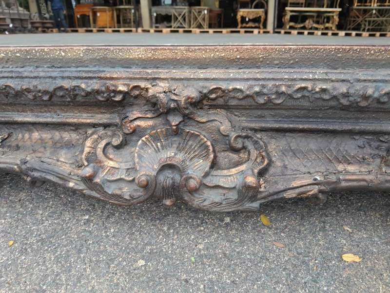 A 20th Century French Style Heavily Carved And Gilded Mirror