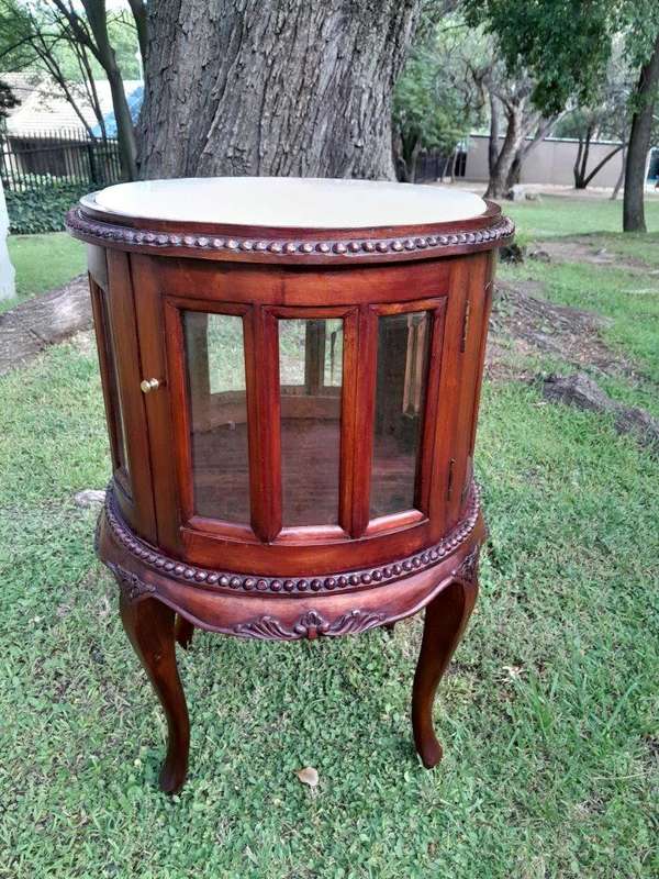 A 20th Century Victorian Ornately Carved Mahogany Drinkscabinet With Cream Marble Top