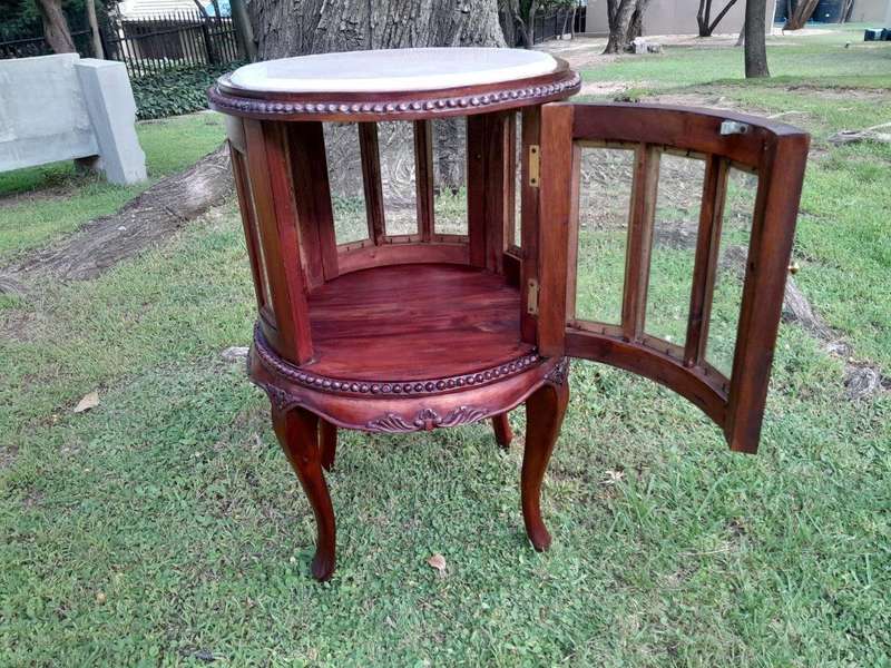 A 20th Century Victorian Ornately Carved Mahogany Drinkscabinet With Cream Marble Top