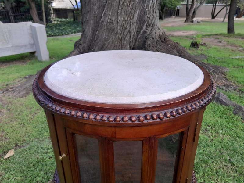 A 20th Century Victorian Ornately Carved Mahogany Drinkscabinet With Cream Marble Top