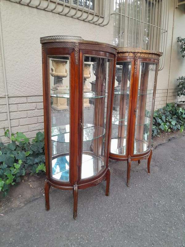 A Rare Near Pair of 20th Century French Style Vitrine / Display Demi Lune Cabinets With Brass Gal...