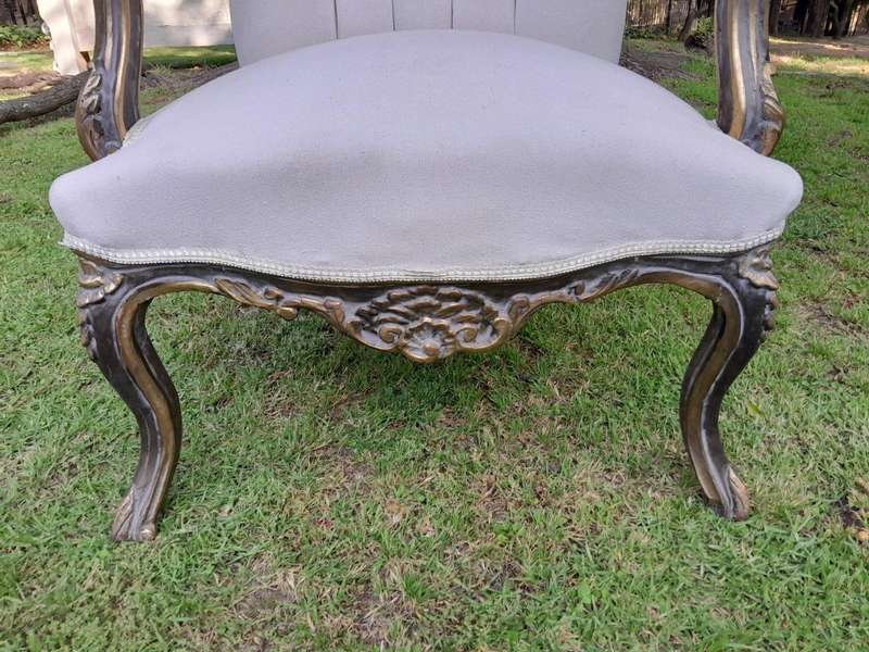 A 20th Century Pair Of French Style Carved And Giltwood High-Back Chairs In Leather
