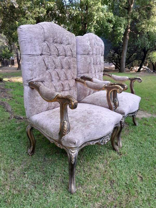 A 20th Century Pair Of French Style Carved And Giltwood High-Back Chairs In Leather
