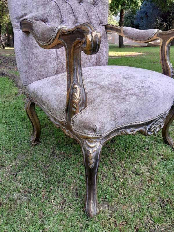 A 20th Century Pair Of French Style Carved And Giltwood High-Back Chairs In Leather