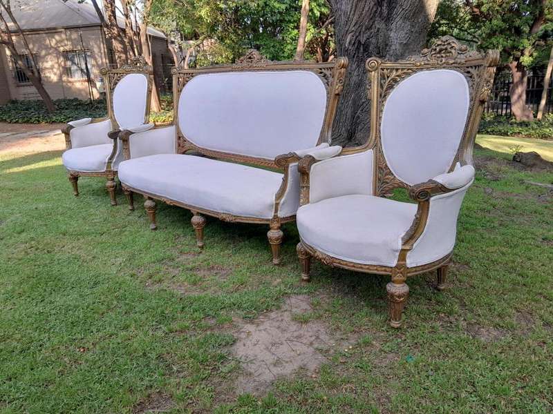 A French Style Giltwood Ornately Carved Settee With A Pair Of Matching Armchairs