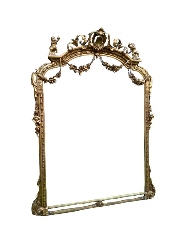 A French Style Ornately Carved And Gilded Bevelled Mirror Of Large Proportions