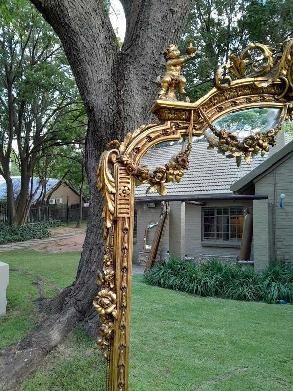 A French Style Ornately Carved And Gilded Bevelled Mirror Of Large Proportions