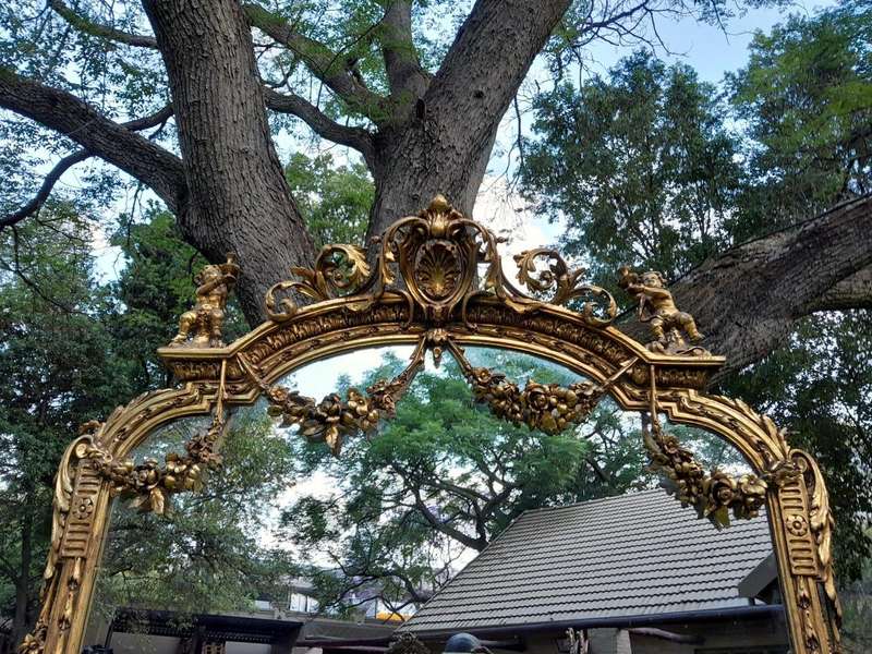 A French Style Ornately Carved And Gilded Bevelled Mirror Of Large Proportions