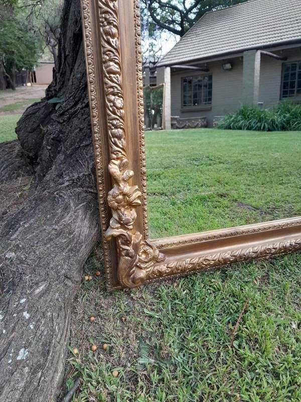 A French Rococo Style Ornately Carved And Gilded Bevelled Mirror